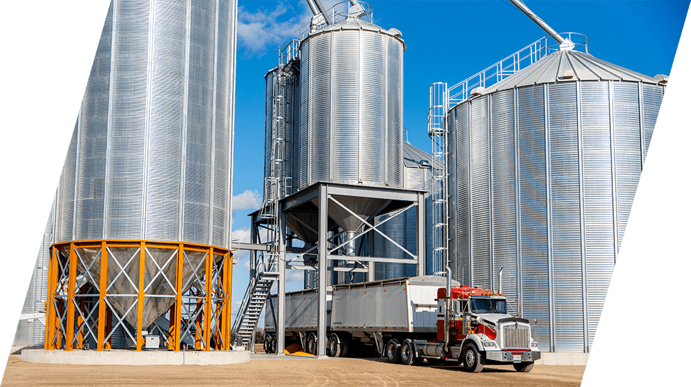 Grain storage bins with unloading truck at Ontario farm